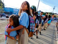 A protective 4th grader Kiera Valentin, 9, assures her little sister Alyssa Rodriguez, 5 kindergarten, that everything will be alright on their first day of school at the Alma del Mar's new school on Belleville Avenue in the north end of New Bedford.   PETER PEREIRA/THE STANDARD-TIMES/SCMG